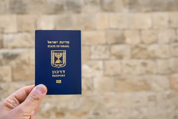 A hand holding Israeli Passport