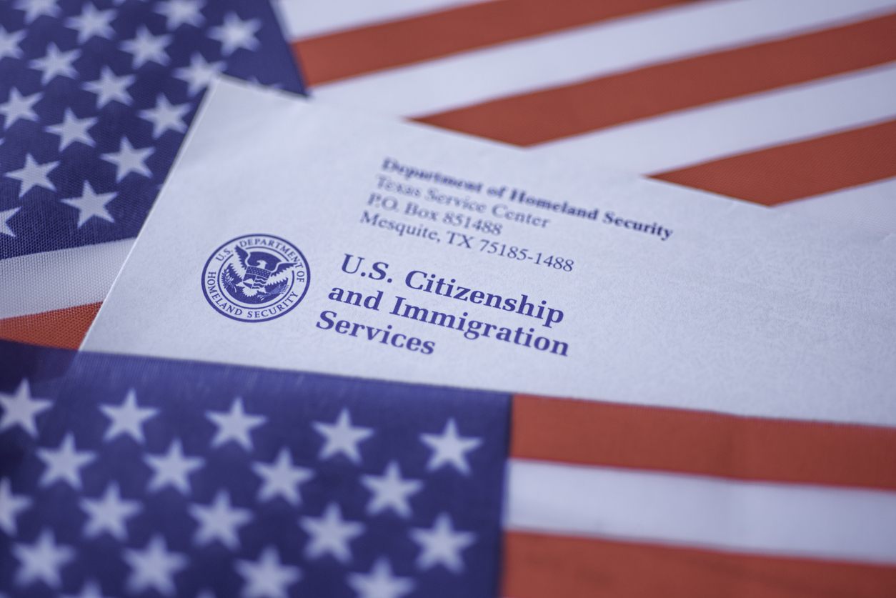 USA flag with a letter from US Citizenship and Immigration Services (USCIS)